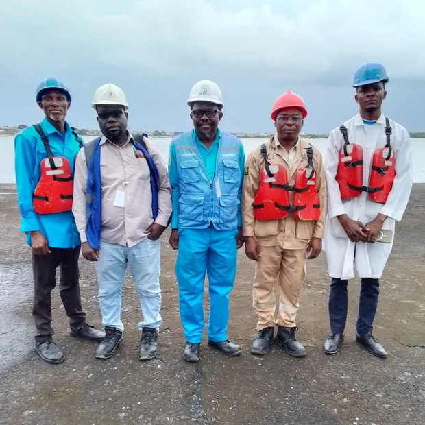 ABUS team in safety gear at a waterfront project site